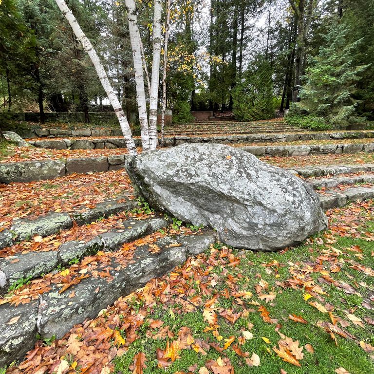Application image for New England Fieldstone - Boulders. The image shows this product being used in a landscape boulders & ledge application. The surface finish shown is weathered. The dominant color shown is gray; with a white secondary. The color mix creates a cool feeling.