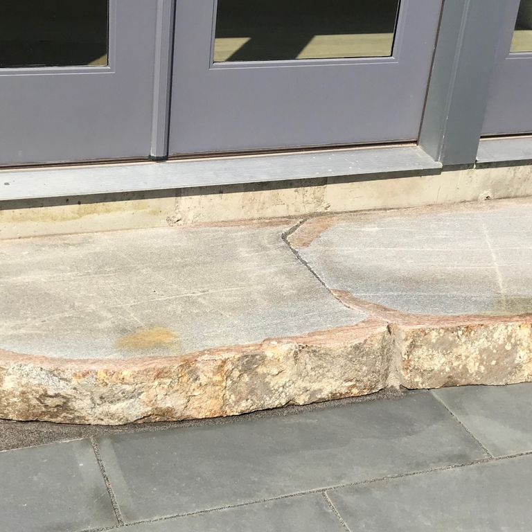 Feature image for New England Fieldstone Boulders - Sawn Landings. The image shows this product being used for landings and monolithic steps. Dominant colors shown are beige, gray and cream; with brown, orange/rust, white and tan secondaries. Exhibits 