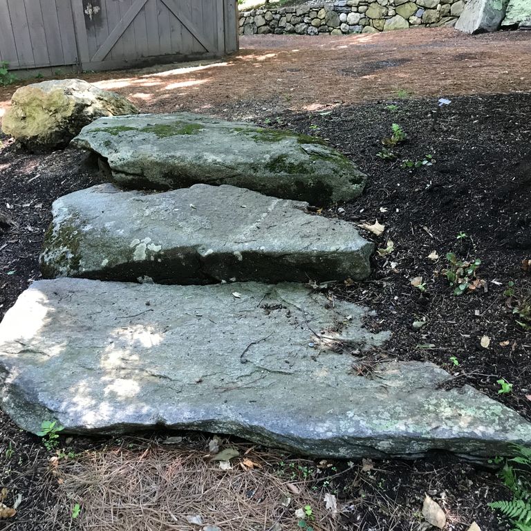 Application image for New England Fieldstone Steppers and Steps. The image shows this product being used in a monolithic steps application. This is a landscape stone for outdoor commercial and residential applications. Suitable for general use, freeze-thaw conditions, high traffic areas and low slipperiness surfaces situations. Moderate to higher on the price spectrum.