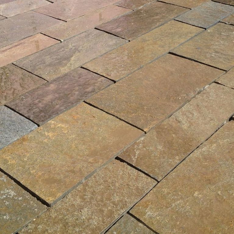 Application image for Granite - Reclaimed Plank Pavers - Sawn Edge. The image shows this product being used for path pavers and patio pavers. The dominant color shown is brown. The color mix creates a warm feeling.
