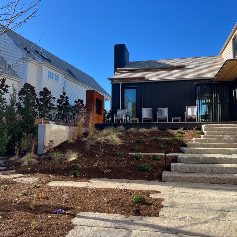 Application image for Granite - Reclaimed First Generation Curbstone Steps - Textured Riser and Tread. The image shows this product being used in a monolithic steps application. Dominant colors shown are gray and tan.