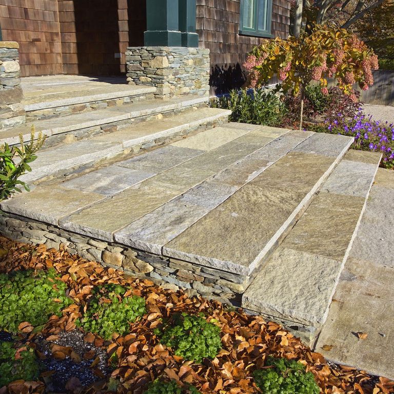 Application image for Reclaimed Granite Treads - Weathered Riser and Tread. The image shows this product being used in a treads application. This is a landscape stone for indoor and outdoor commercial and residential applications. Suitable for general use, freeze-thaw conditions, low heat absorption surfaces, high traffic areas, low slipperiness surfaces and high heel compatibilty situations. Higher to high on the price spectrum.