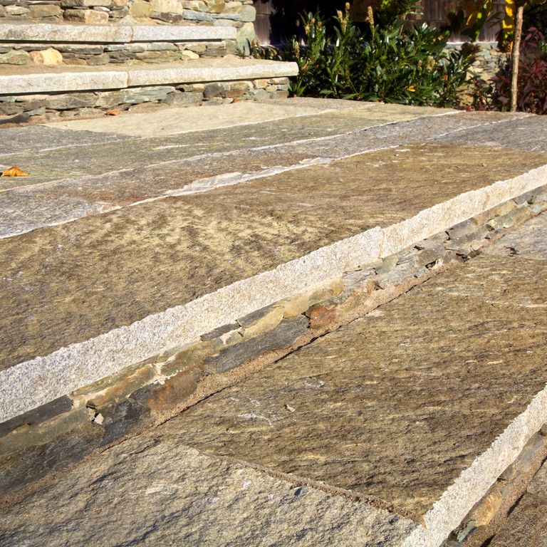 Application image for Reclaimed Granite Treads - Weathered Riser and Tread. The image shows this product being used in a treads application. This is a landscape stone for indoor and outdoor commercial and residential applications. Suitable for general use, freeze-thaw conditions, low heat absorption surfaces, high traffic areas, low slipperiness surfaces and high heel compatibilty situations. Higher to high on the price spectrum.