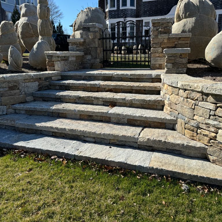 Application image for Reclaimed Granite Treads - Weathered Riser and Tread. The image shows this product being used in a treads application. Dominant colors shown are beige, gray and tan. The color mix creates a warm feeling.