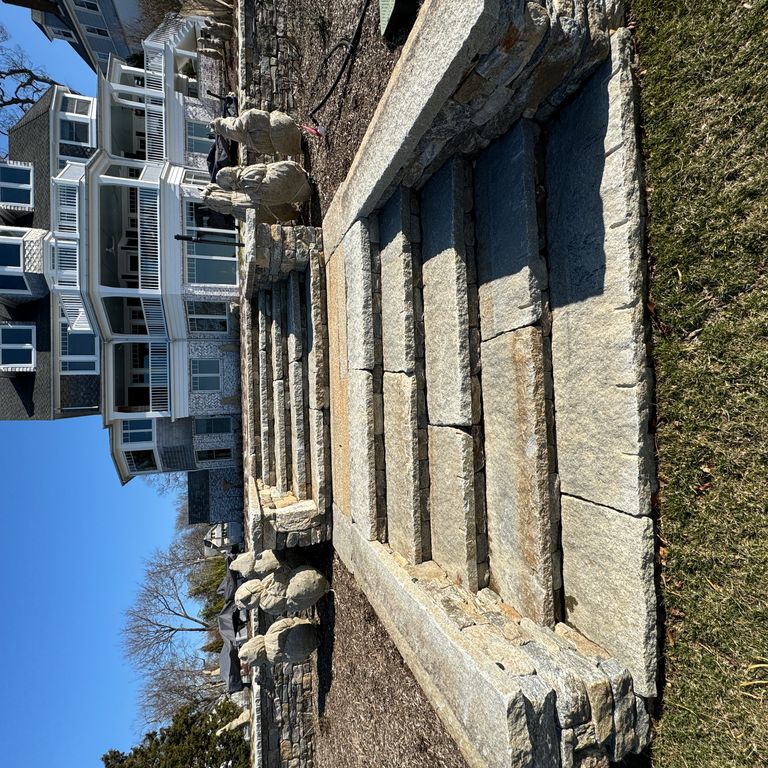 Application image for Reclaimed Granite Treads - Weathered Riser and Tread. The image shows this product being used in a treads application. Dominant colors shown are blue and gray. The color mix creates a cool feeling.