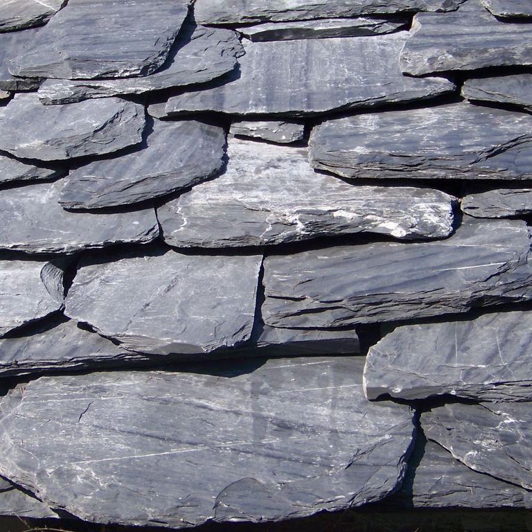 Application image for Vermont Slate Striated Gray - Roof Shingles. The image shows this product being used in a Roof Shingles application. The surface finish shown is natural cleft. Dominant colors shown are blue and gray; with a white secondary. Exhibits 