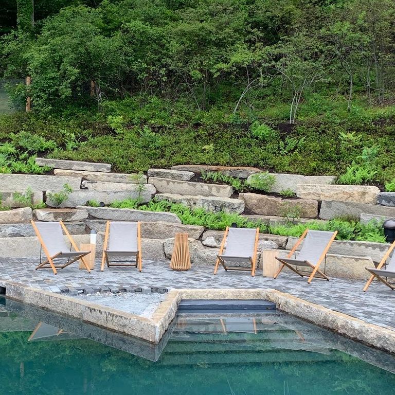 Application image for Reclaimed Granite Curbstone - Pool Coping. The image shows this product being used in a pool coping application. The surface finish shown is . The dominant color shown is gray. The color mix creates a cool feeling.