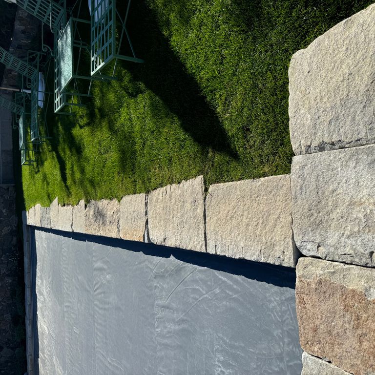 Application image for Granite - Reclaimed Curbstone - Pool Coping. The image shows this product being used in a pool coping application. The surface finish shown is . The dominant color shown is gray. The color mix creates a warm feeling. Regular and random color patterns.