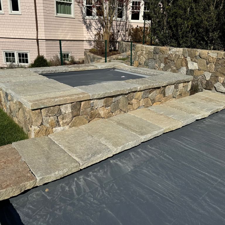 Application image for Granite - Reclaimed Curbstone - Pool Coping. The image shows this product being used in a pool coping application. Dominant colors shown are brown and tan. The color mix creates a warm feeling.