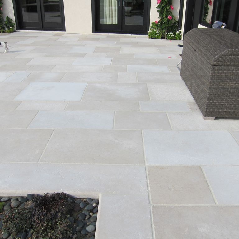 The image shows this product being used in a patio pavers application.
