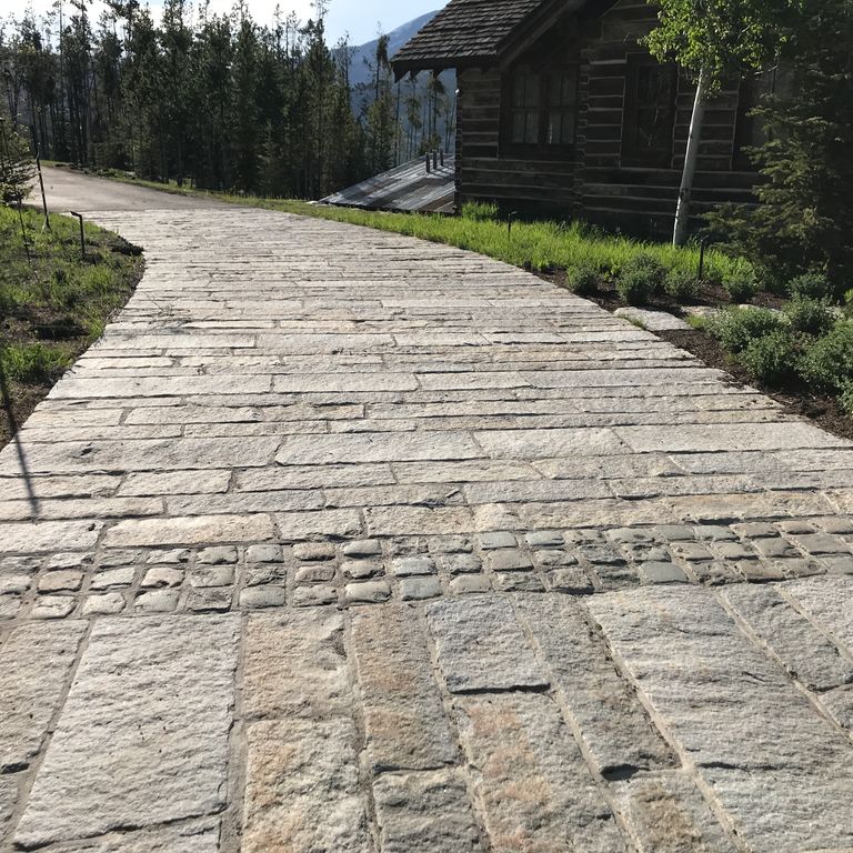 The image shows this product being used in a driveway pavers application.