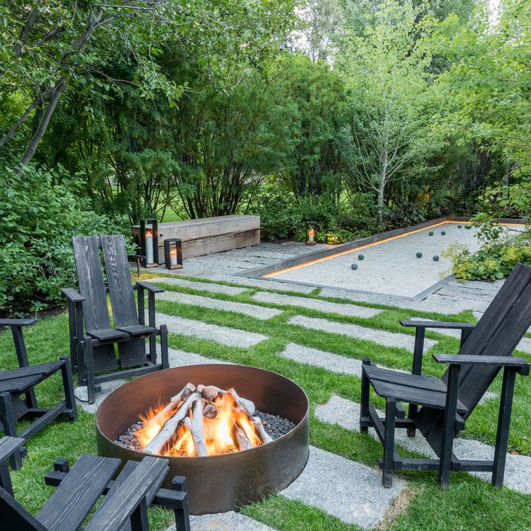 Application image for Reclaimed First Generation Granite Curbstone Plank Pavers. The image shows this product being used in a patio pavers application. The surface finish shown is a combination of weathered and worn. The dominant color shown is gray. The color mix creates a cool feeling. Speckled color pattern.