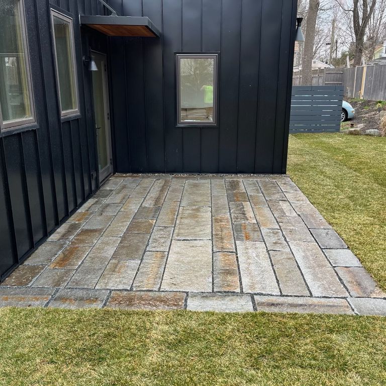 Application image for Granite - Reclaimed Second Generation Curbstone - Plank Pavers. The image shows this product being used in a patio pavers application. The dominant color shown is gray.