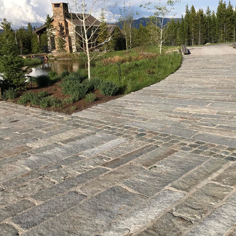The image shows this product being used in a driveway pavers application.