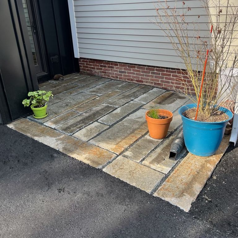 Application image for Granite - Reclaimed Second Generation Curbstone - Plank Pavers. The image shows this product being used in a patio pavers application. The dominant color shown is gray.