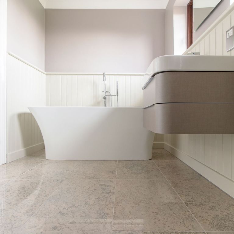 Feature image for Mountain Hard Limestone Blue - Interior Flooring. The image shows this product being used in an interior floor application. Dominant colors shown are gray and tan; with beige, brown, purple and white secondaries. Exhibits 