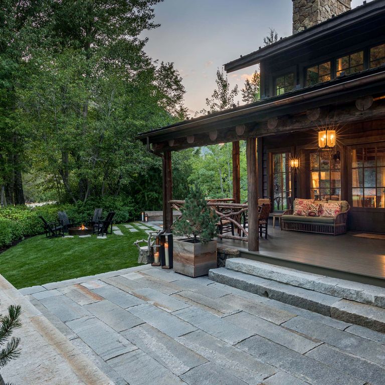Application image for Reclaimed Third Generation Granite Curbstone Plank Pavers. The image shows this product being used in a patio pavers application. The dominant color shown is gray; with an orange/rust secondary. The color mix creates a cool feeling.