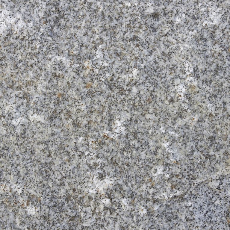 Color/Finish variation image for Reclaimed First Generation Granite Curbstone Edging. The dominant color shown is gray; with beige, brown, green and white secondaries. The color mix creates a cool feeling. Speckled, fine speckled, blotched and cloudy color patterns. Contains mineral inclusions.