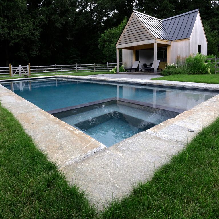 Feature image for Granite- Reclaimed Curbstone - Jumbo Pool Coping. The image shows this product being used for pool coping and pool deck pavers. The surface finish shown is . Dominant colors shown are beige and gray; with brown, white, tan and cream secondaries. The color mix creates a cool feeling. Regular, speckled and blotched color patterns.