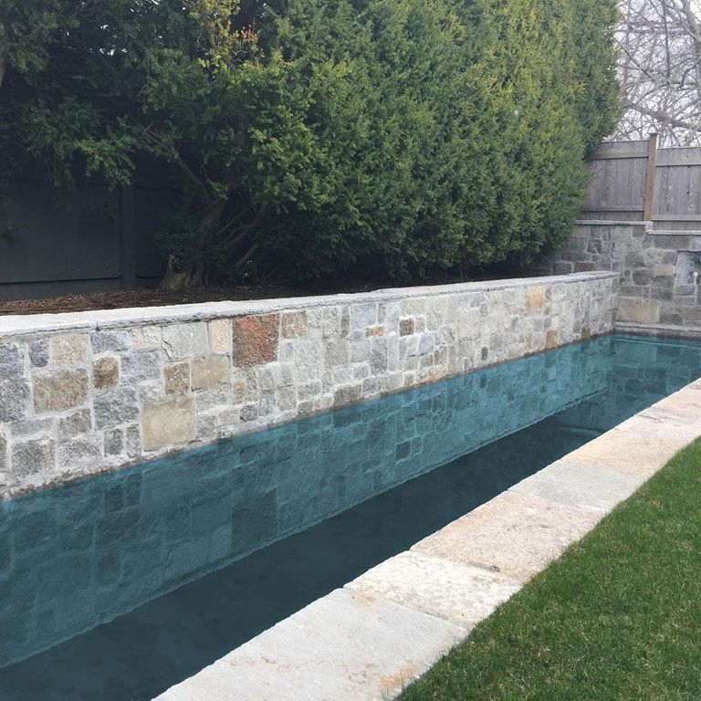 The image shows this product being used for pool coping, pool deck pavers and . The surface finish shown is . Dominant colors shown are gray, white and cream; with beige and tan secondaries. The color mix creates a warm feeling. Regular and fine speckled color patterns.