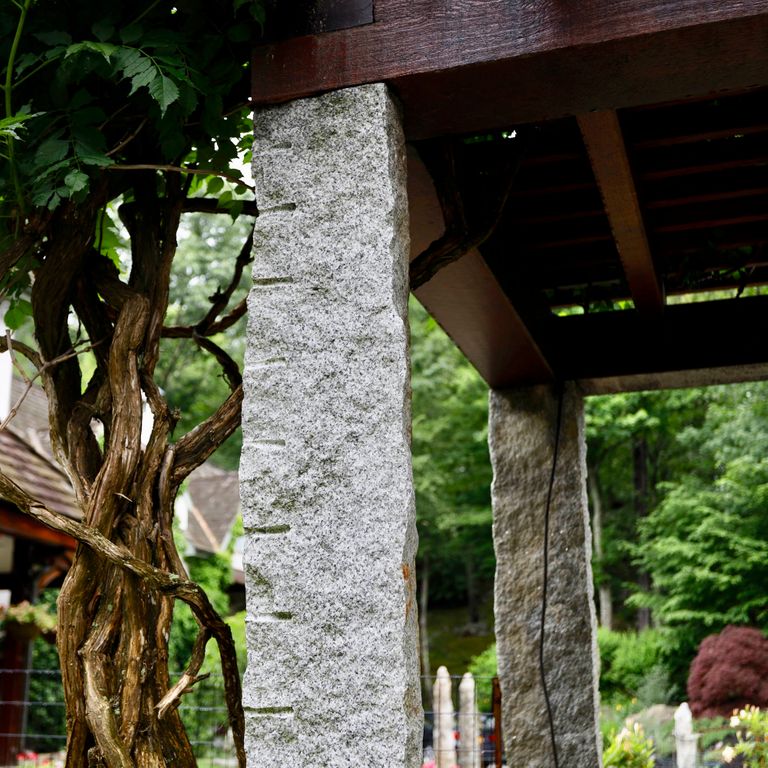 Application image for Reclaimed Granite Columns. The image shows this product being used in a columns application. This is a landscape stone for outdoor commercial and residential applications. Suitable for general use situations. Moderate to high on the price spectrum.