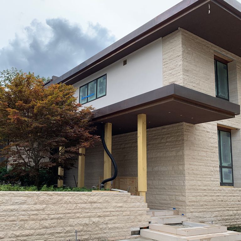 Application image for Mountain Hard Limestone Beige - Wall Veneer. The image shows this product being used for landscape wallstone and full bed veneer. The surface finish shown is a combination of pillowed and rockfaced. The dominant color shown is beige. The color mix creates a warm feeling.