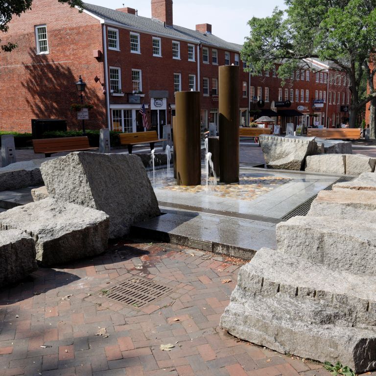 Feature image for Granite - Reclaimed Block - Benches. The image shows this product being used in a seating & benches application. The surface finish shown is . The dominant color shown is gray; with beige, white and tan secondaries. The color mix creates a cool feeling. Regular and speckled color patterns.