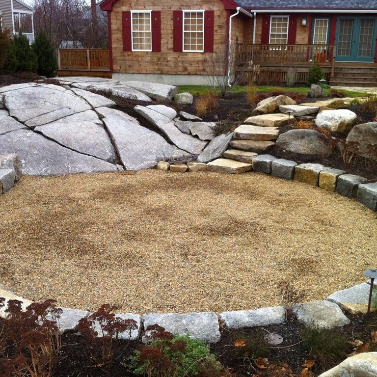 Application image for Granite - Reclaimed Block - Benches. The image shows this product being used in a seating & benches application. The surface finish shown is weathered. The dominant color shown is gray. The color mix creates a warm feeling. Regular color pattern.