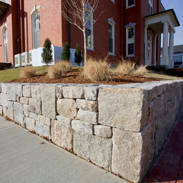 The image shows this product being used in a landscape wallstone application.