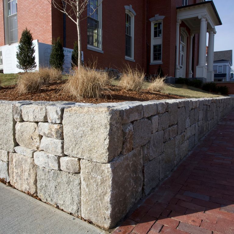 The image shows this product being used in a landscape wallstone application.