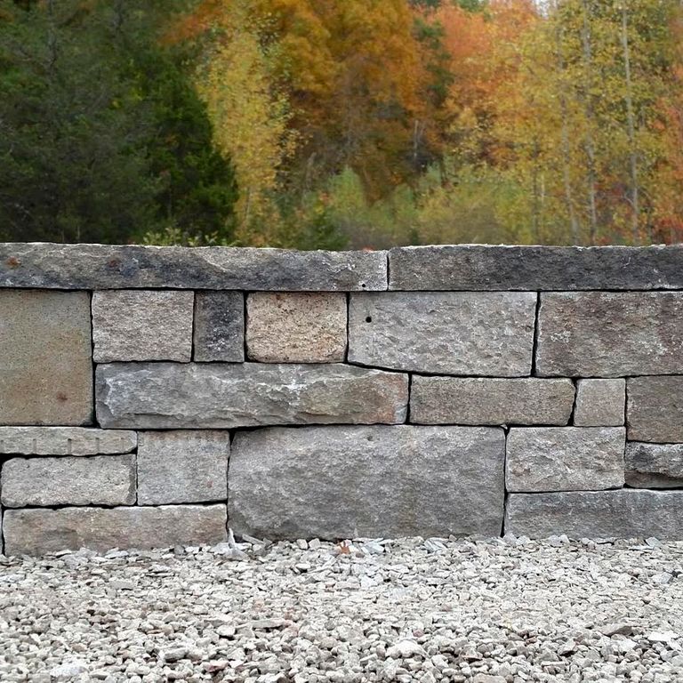 Application image for Granite - Reclaimed Block Wallstone - Block Mix. The image shows this product being used for wallstone cap, landscape wallstone, columns and posts.