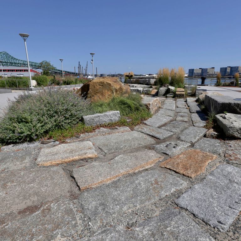 Application image for Reclaimed Granite Block - Pavers. The image shows this product being used in a patio pavers application. The surface finish shown is . The dominant color shown is gray.
