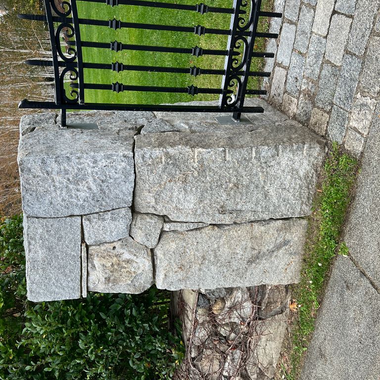 Application image for Granite - Reclaimed New England Quarry Tailings - Oversized Wallstone. The image shows this product being used in a landscape wallstone application. The dominant color shown is gray.