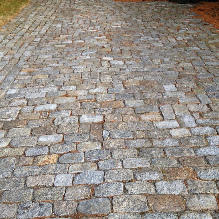 The image shows this product being used in a driveway pavers application.