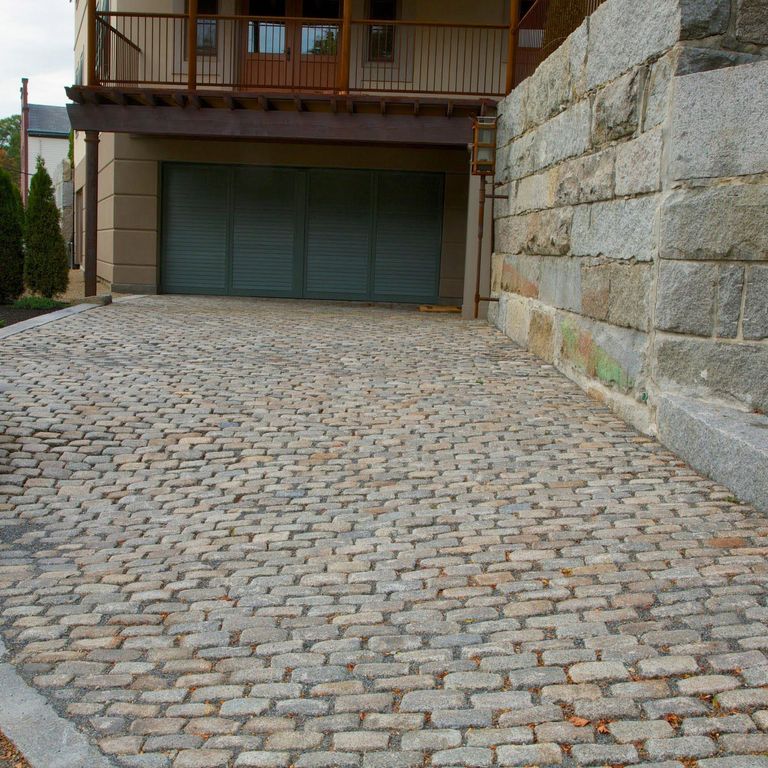The image shows this product being used in a driveway pavers application.