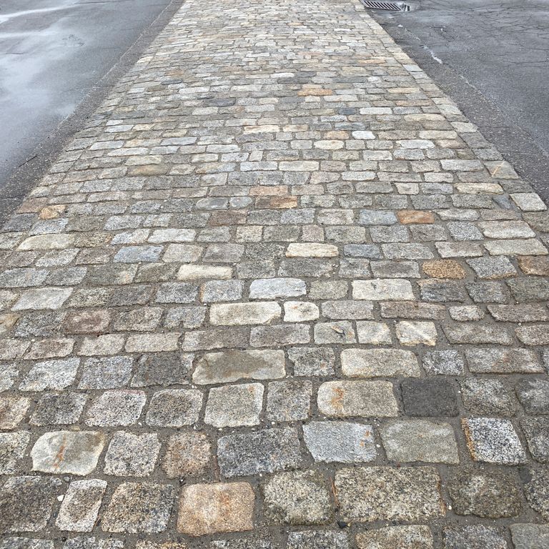 The image shows this product being used in a driveway pavers application.
