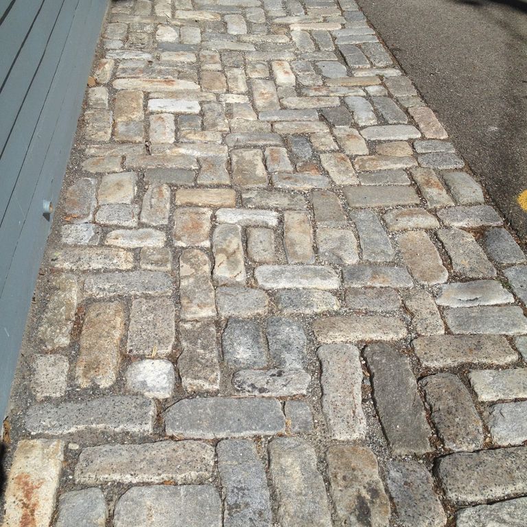 The image shows this product being used in a path pavers application.