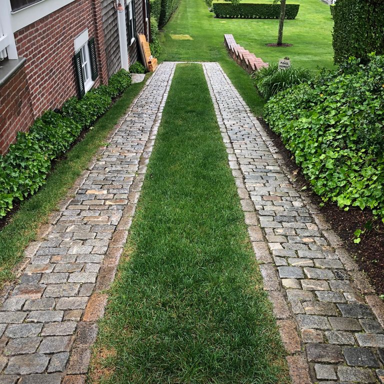 The image shows this product being used in a driveway pavers application.