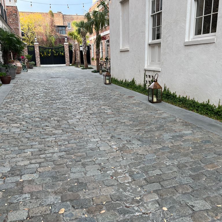 Application image for Reclaimed European Porphyry Cobblestones - Rectangle - Worn. The image shows this product being used in a path pavers application. The surface finish shown is . The dominant color shown is gray. The color mix creates a warm feeling.