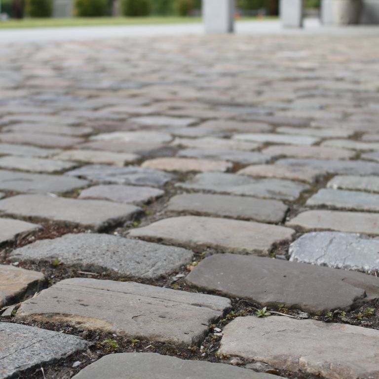 Application image for Reclaimed European Sandstone Cobblestones - Rectangle - Worn Surface. The image shows this product being used in a driveway pavers application. The surface finish shown is . The dominant color shown is gray.