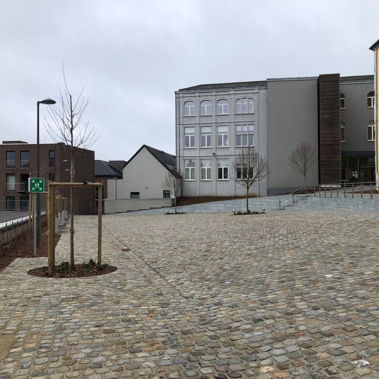 Application image for Reclaimed European Sandstone Cobblestones - Rectangle - Worn Surface. The image shows this product being used for patio pavers and public area. The surface finish shown is . The dominant color shown is gray. The color mix creates a warm feeling.