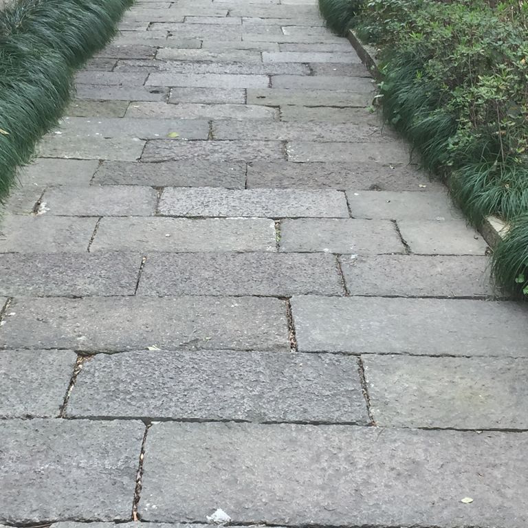 The image shows this product being used in a path pavers application.