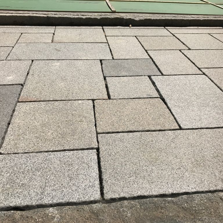The image shows this product being used in a patio pavers application.