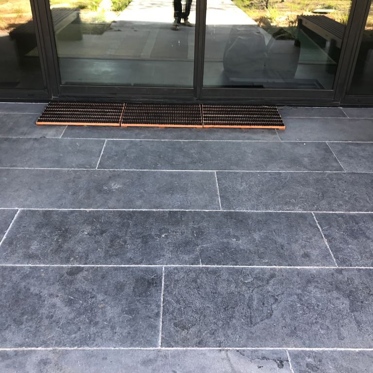 The image shows this product being used in a patio pavers application.