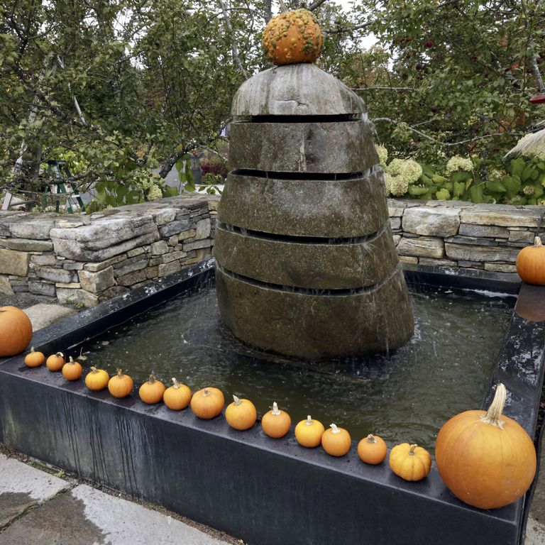 Application image for New England Fieldstone Boulders & Ledgestone - Fountains & Lights. The image shows this product being used for water features and garden accents. The surface finish shown is weathered. The dominant color shown is gray.