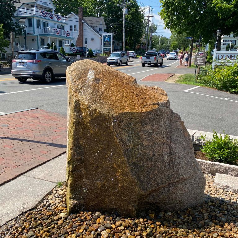 Application image for New England Fieldstone Boulders & Ledgestone - Fountains & Lights. The image shows this product being used for water features and landscape boulders & ledge. The surface finish shown is weathered. The dominant color shown is gray.