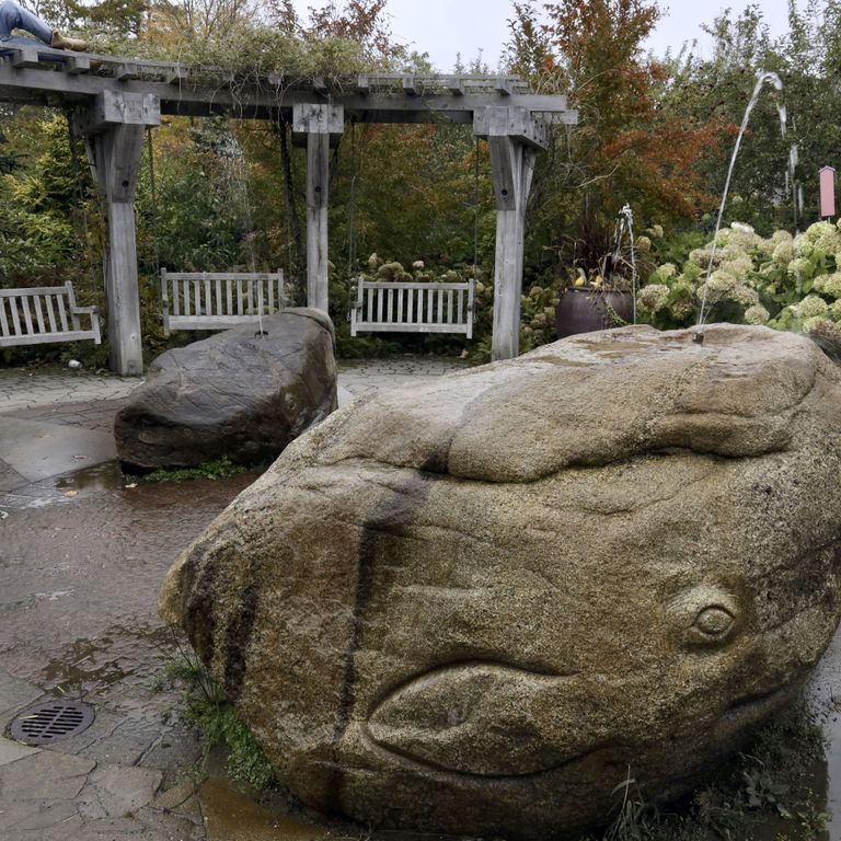 Application image for New England Fieldstone Boulders & Ledgestone - Fountains & Lights. The image shows this product being used for water features and garden accents. The surface finish shown is weathered. The dominant color shown is gray.