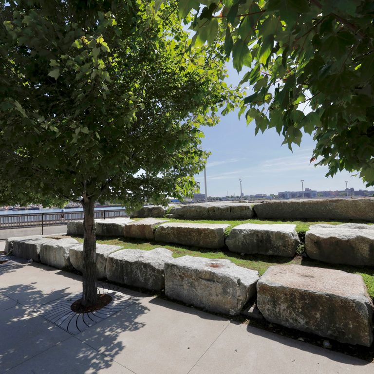 Application image for Reclaimed Granite Bridge Blocks - Benches and Seating. The image shows this product being used for seating & benches and landscape wallstone. The surface finish shown is . Dominant colors shown are brown and gray. Regular color pattern.