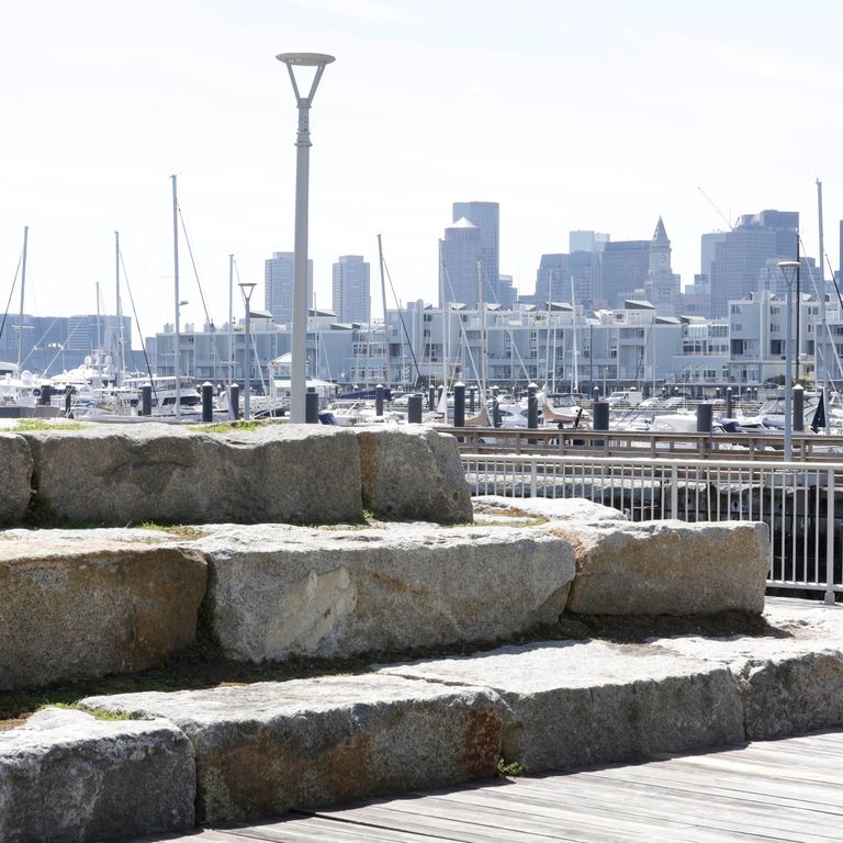 Application image for Reclaimed Granite Bridge Blocks - Benches and Seating. The image shows this product being used for seating & benches and landscape wallstone. The surface finish shown is . The dominant color shown is gray. The color mix creates a cool feeling. Regular color pattern.