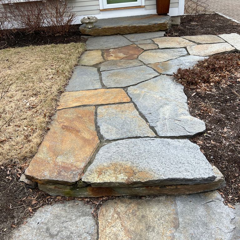 Application image for Goshen Stone - Irregular Flagstone. The image shows this product being used for path pavers and monolithic steps. The surface finish shown is split-face with flat plane. Dominant colors shown are brown, gray, orange/rust and tan. The color mix creates a warm feeling. Regular and blotched color patterns. Contains lots of mica and mineral inclusions.